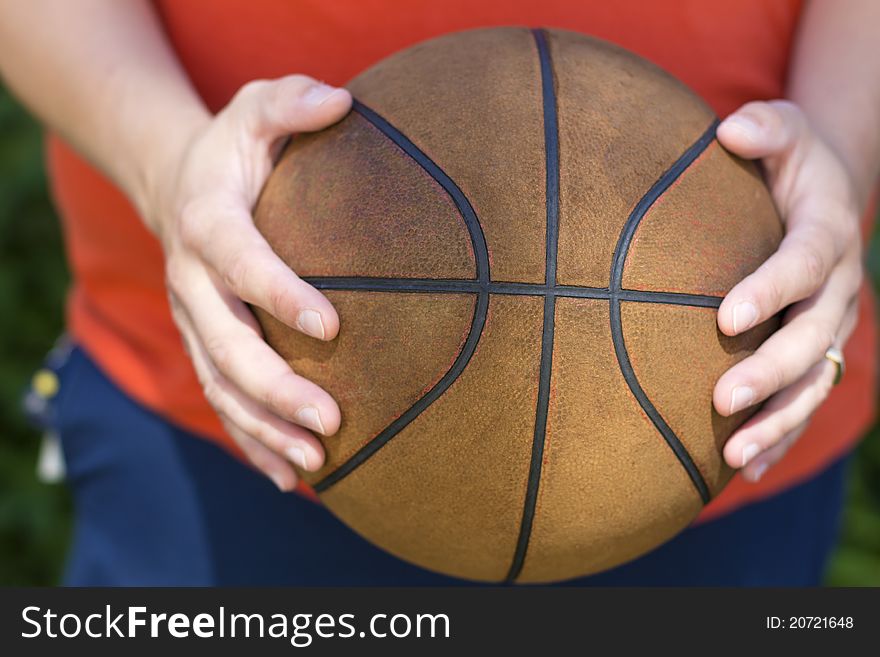 Player holding his old basketball.