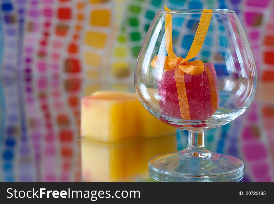 Colorful ice cube in brandy glass. Colorful ice cube in brandy glass