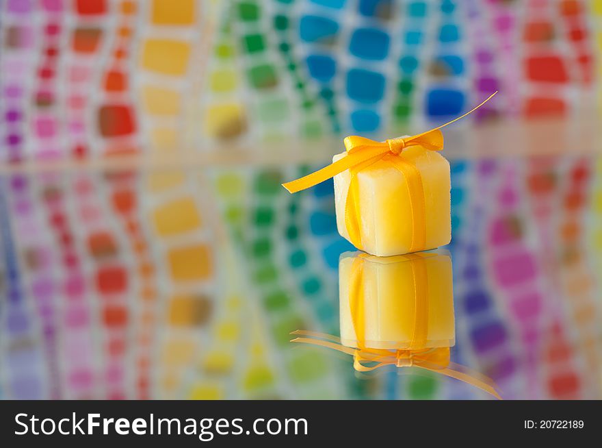 Yellow Ice cube on a colorful background