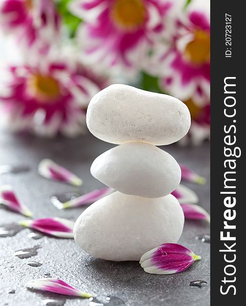 Stacked white stones and petals. Stacked white stones and petals