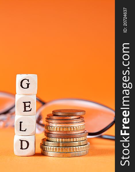 Euro coins and glasses with word geld in german. Euro coins and glasses with word geld in german