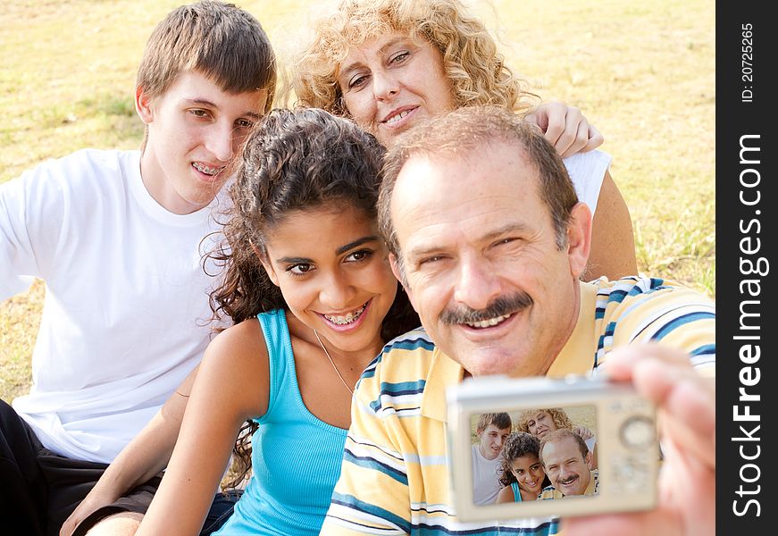 Attractive family pose for a self portrait outdoors.