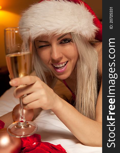 Portrait of girl in Santa hat with the glasses of champagne waiting for New Year. Portrait of girl in Santa hat with the glasses of champagne waiting for New Year