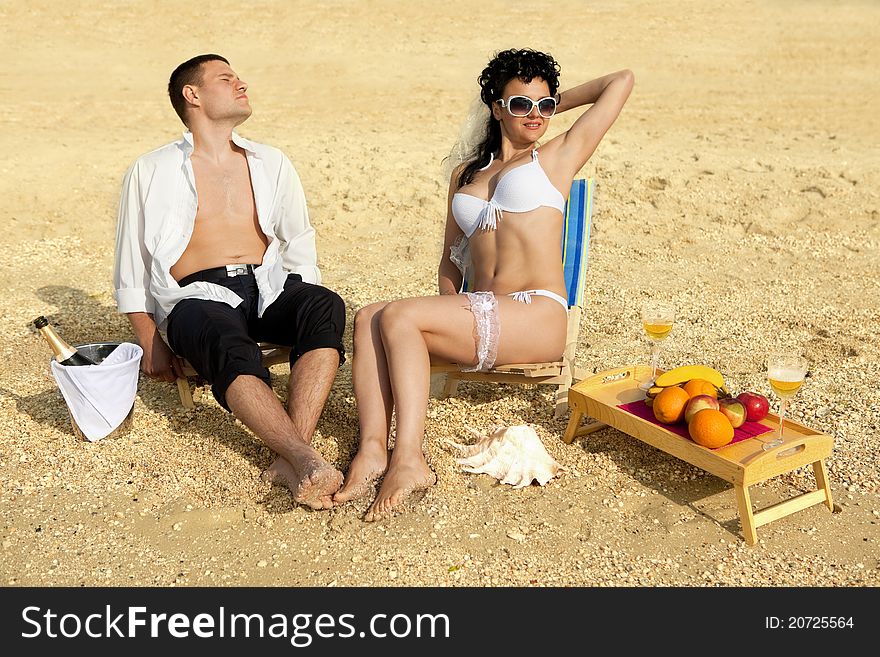 Couple Resting On The Beach