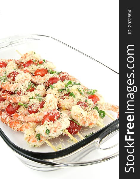 Shrimp kebabs in a glass dish ready for grilling.