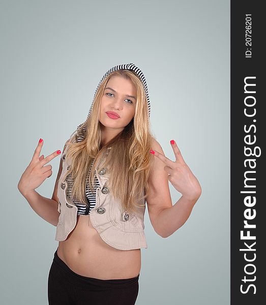 Blonde girl posing , and she is showing peace sign with both her hands. Blonde girl posing , and she is showing peace sign with both her hands.