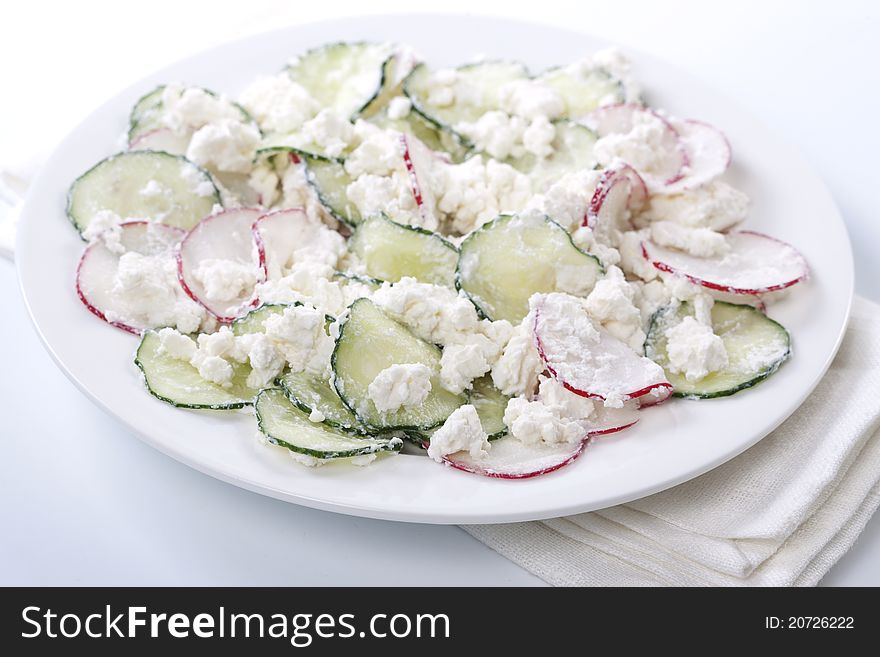 Fresh radish salad with cucumber and cheese