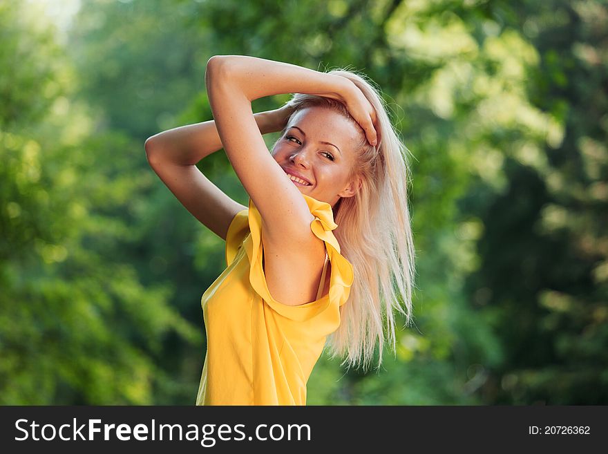 Happy woman posing against a background of trees. Happy woman posing against a background of trees