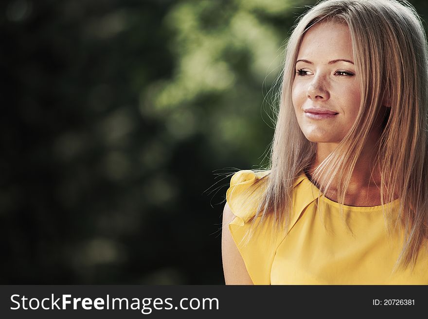 Happy woman posing against a background of trees. Happy woman posing against a background of trees