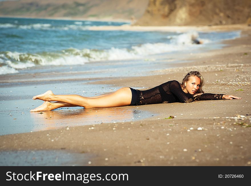 The lonely girl on an ocean coast