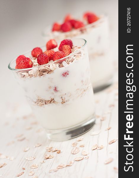 Natural yogurt with muesli and wild strawberries. Natural yogurt with muesli and wild strawberries