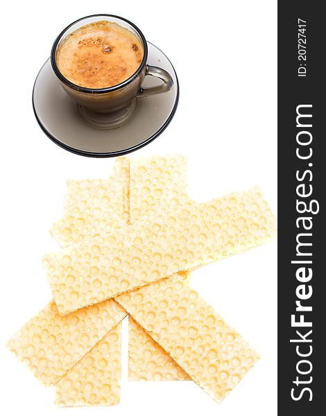Cappuccino and wafer bread over white background