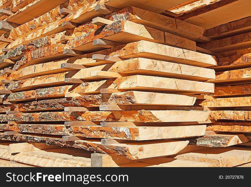 Stack of new wooden studs at the lumber yard. Stack of new wooden studs at the lumber yard