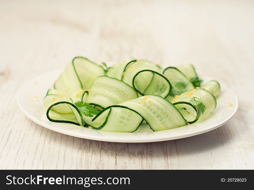 Sliced green cucumbers salad with cilantro