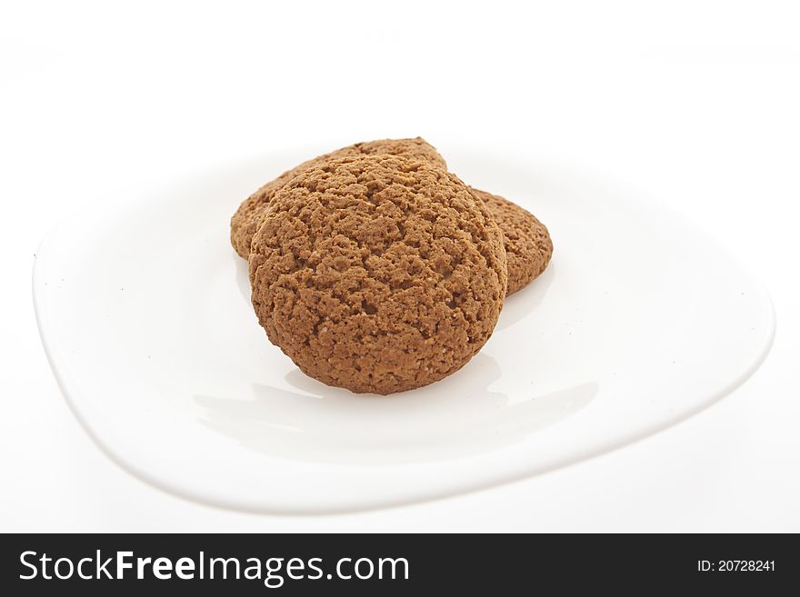 Small round handmade cookies on a white dish