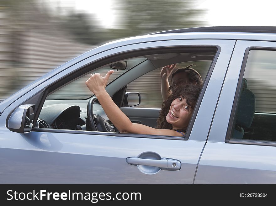 Happy young couple in car. girl with thumb up. Happy young couple in car. girl with thumb up