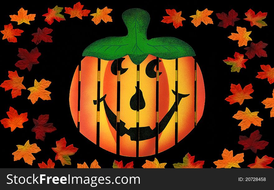 Wooden Pumpkin with Colorful Leaves isolated on black background