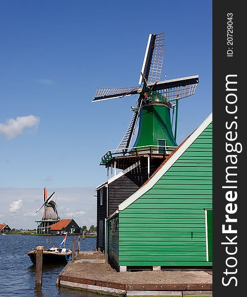 Dutch Country side green windmills at the border of the lake