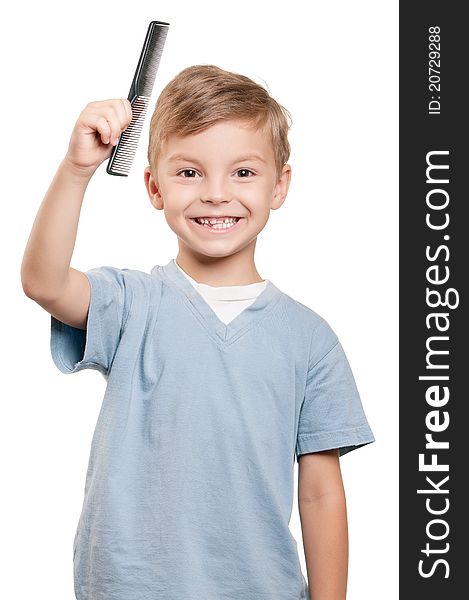 Portrait of a little boy holding a comb over white background. Portrait of a little boy holding a comb over white background