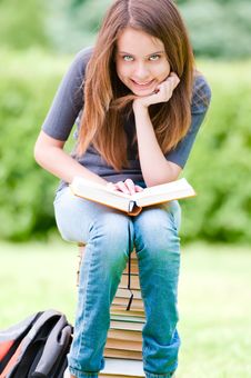 Happy Student Girl Sitting On Pile Of Books Stock Photo Happy Student Girl Sitting On Pile Of Books Stock Photo