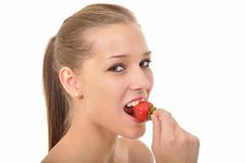Woman With Braids Biting Into A Strawberry Stock Image
