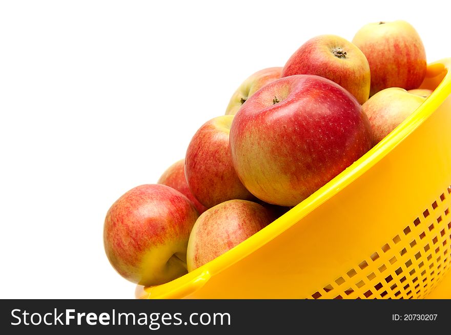 Apples in bowl on white background.