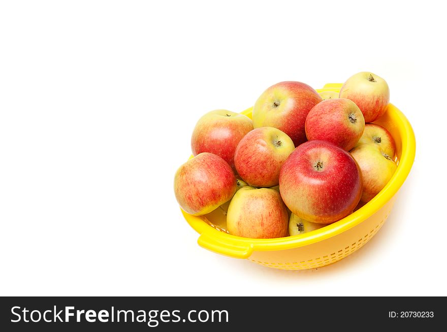 Apples in bowl on white background.