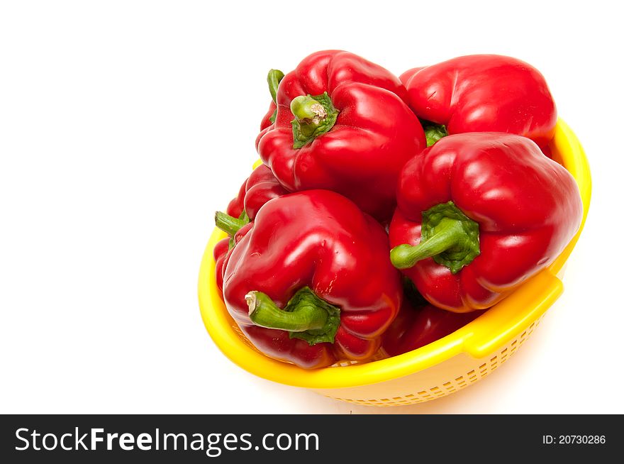 Red paprika in a bowl on white background