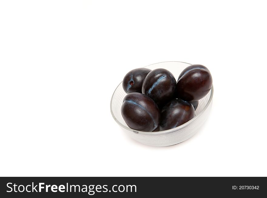 Close up of fresh three plum on white background