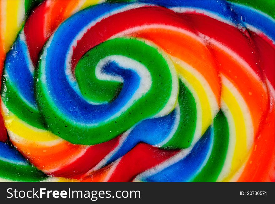 Abstract view of old fashioned swirled lollipop with water drops on it. Abstract view of old fashioned swirled lollipop with water drops on it