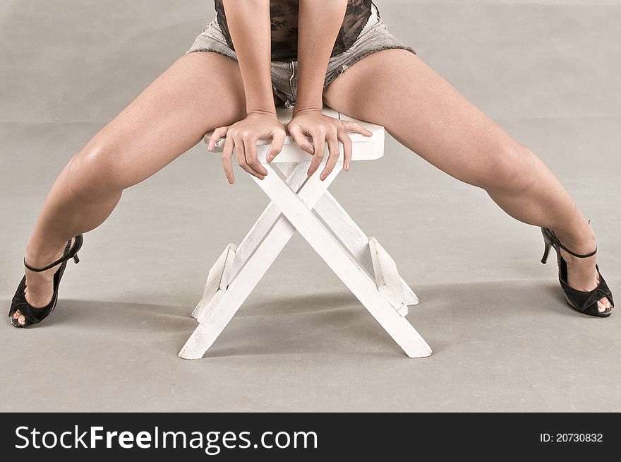 Legs of a woman while sitting down. Legs of a woman while sitting down