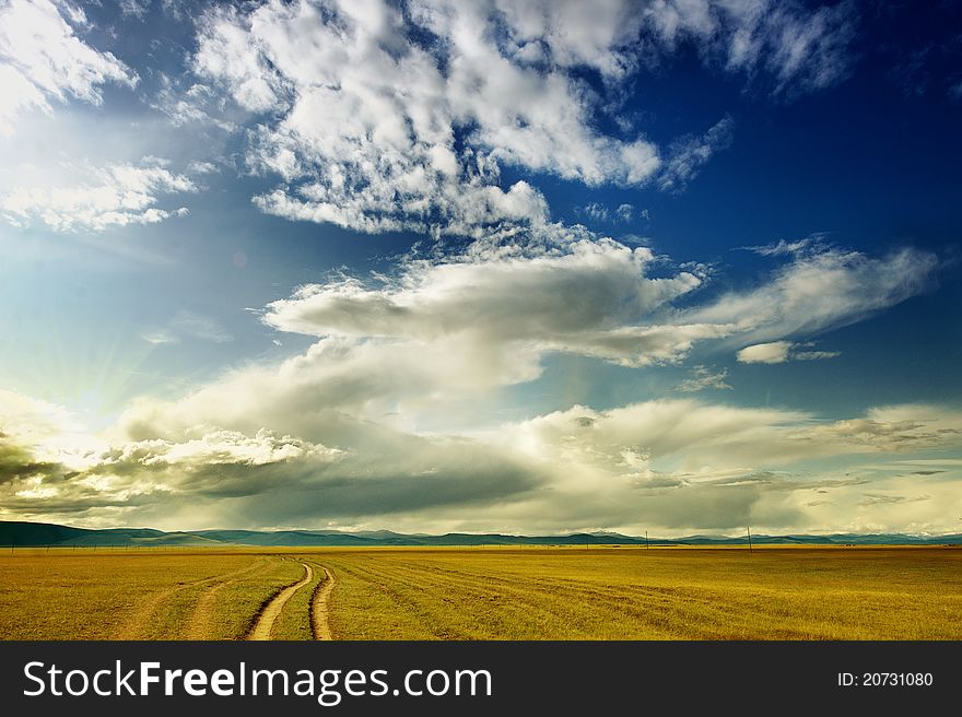 Mongolian Rural Road with Cloudy Blue Skies