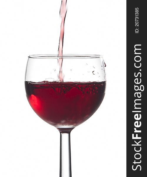 Bubbles from pouring red wine into a glass against a white background. Bubbles from pouring red wine into a glass against a white background.