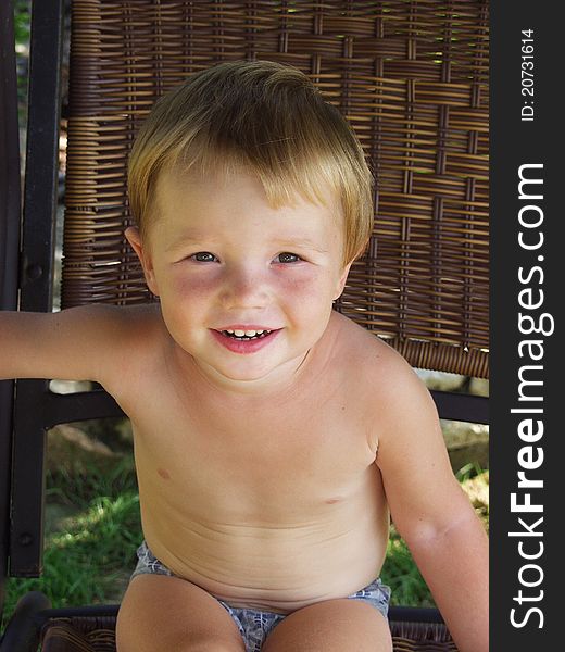 Smiling baby. Portrait of a boy in the garden