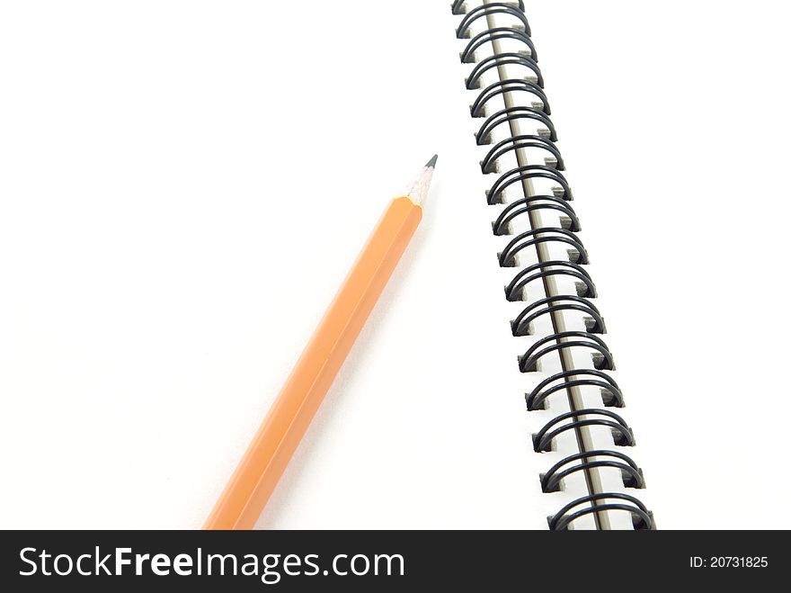 Spiral notebook with pencil against white background. Spiral notebook with pencil against white background.