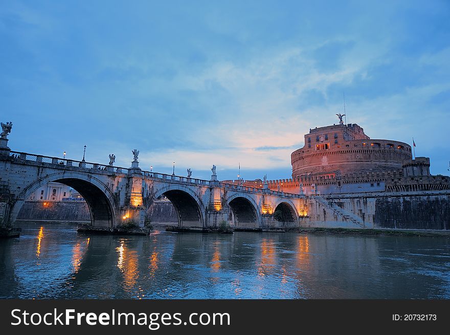 Bridge crossing the river Tiber and Castle in twilight