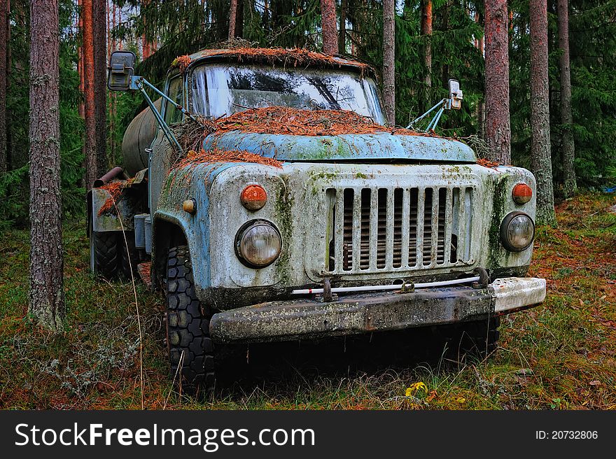 Old tank truck in the coniferous forest