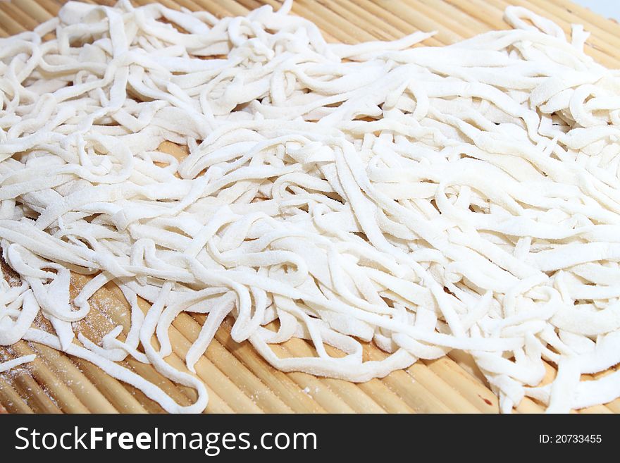 Cooking noodle with white paste and flour.