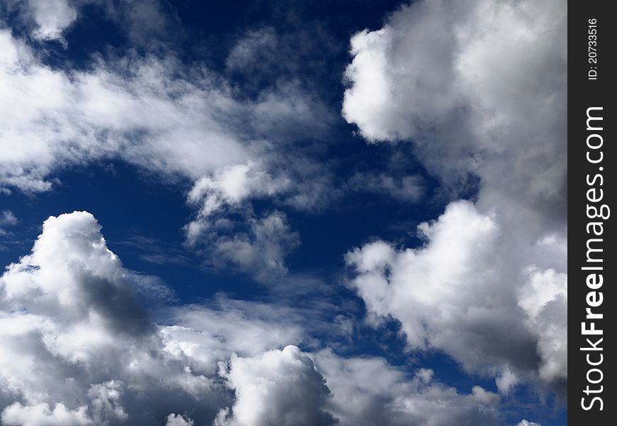 Brightly lit clouds against a blue sky. Brightly lit clouds against a blue sky