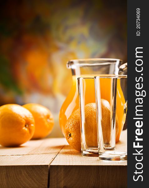 Composition of emty glass and orange juice with oranges on wooden boards. Composition of emty glass and orange juice with oranges on wooden boards