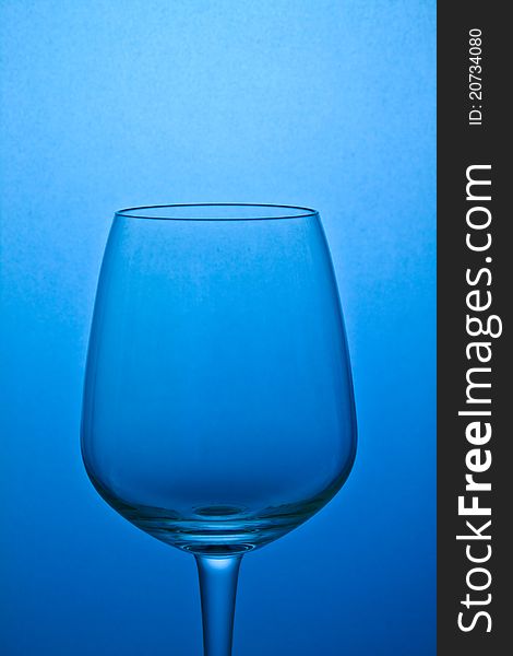 Empty wine glass isolated on blue background