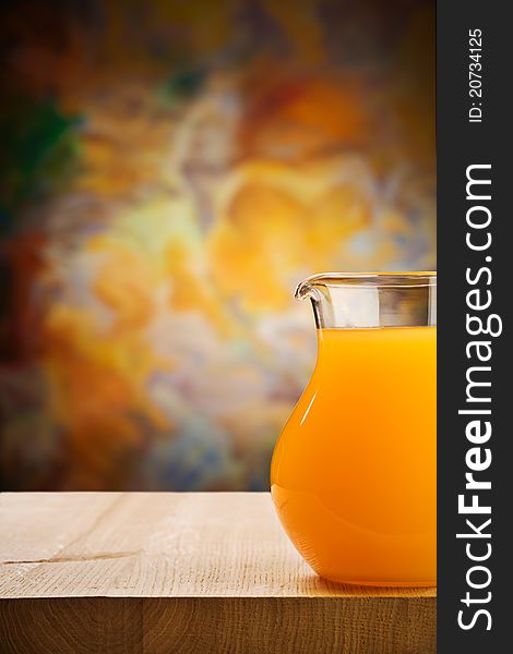 Studio shot copy space image composition of glass jug of the oranges juice on wooden boards