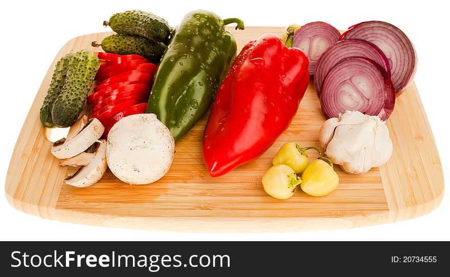 Various fresh vegetables on wooden cutting board, isolated on white. Various fresh vegetables on wooden cutting board, isolated on white