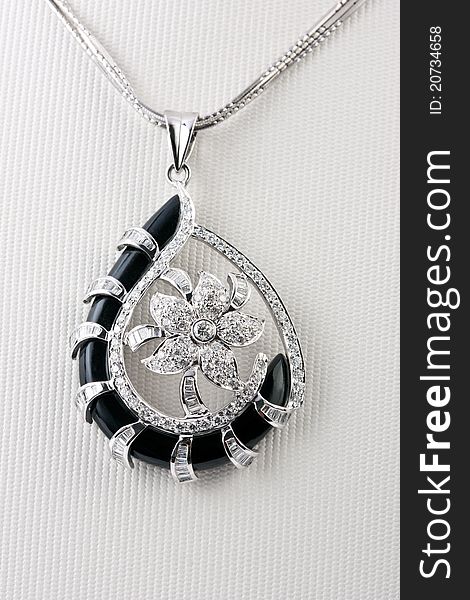 Close up of diamond pendant isolated over white background