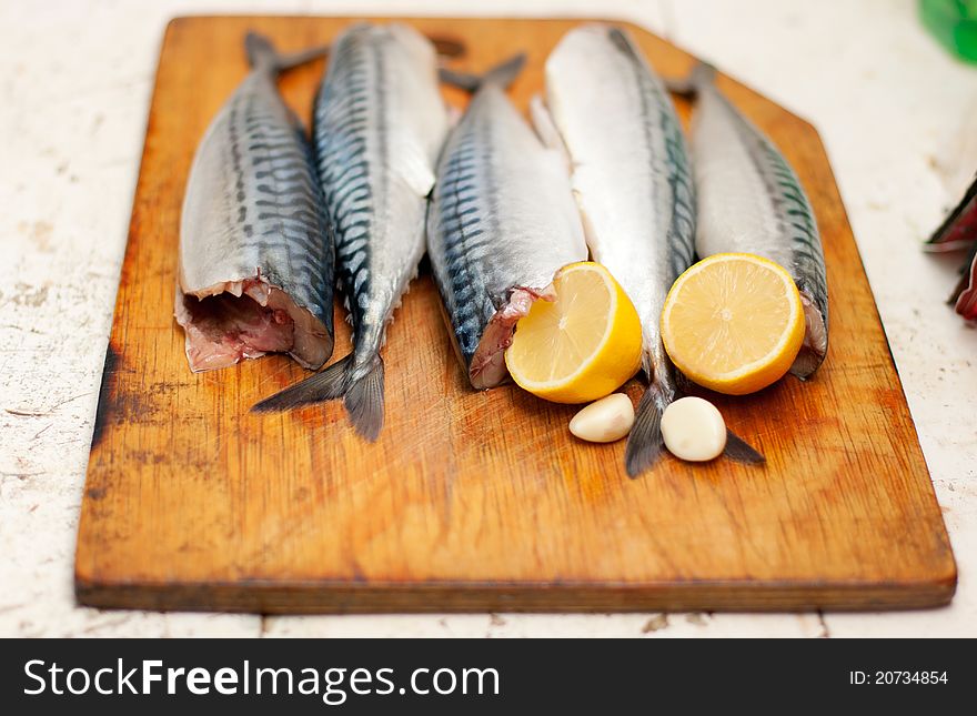 Fish carcass with spices on wooden hardboard, prepared for cooking