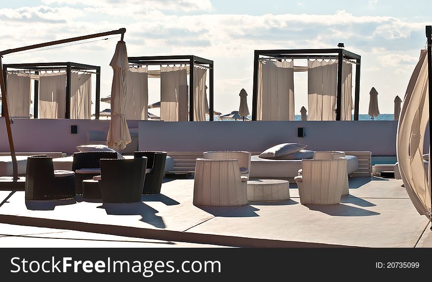 Luxury hotel resort patio with a wooden and a plastic furniture. . Luxury hotel resort patio with a wooden and a plastic furniture. .