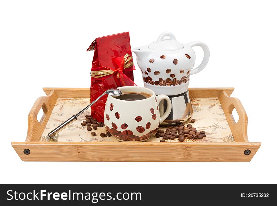 Coffee pot with cup, red bag on wooden tray, isolated