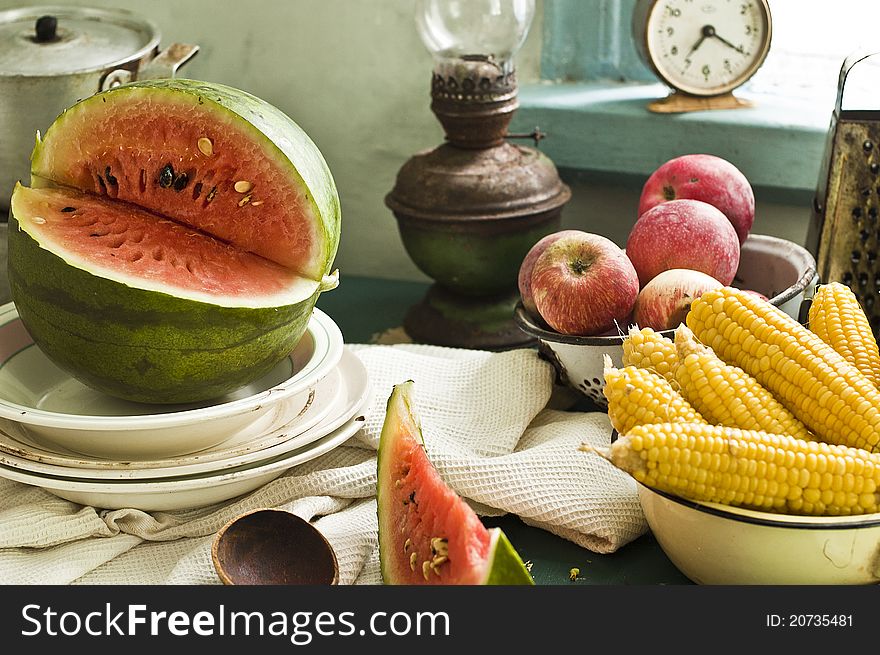 Fruit and vegetables with tableware on a table