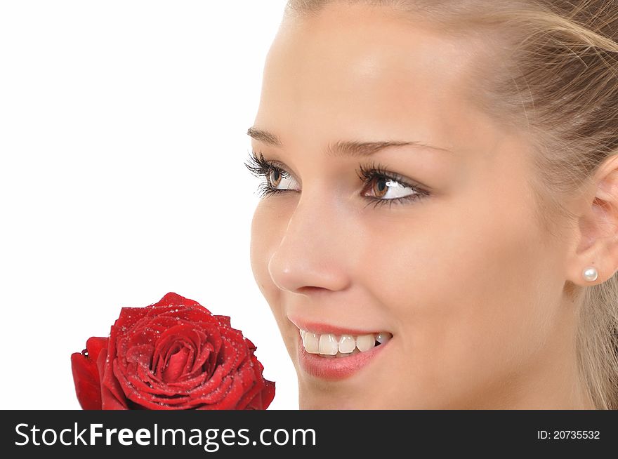 Young woman with rose full of water drops