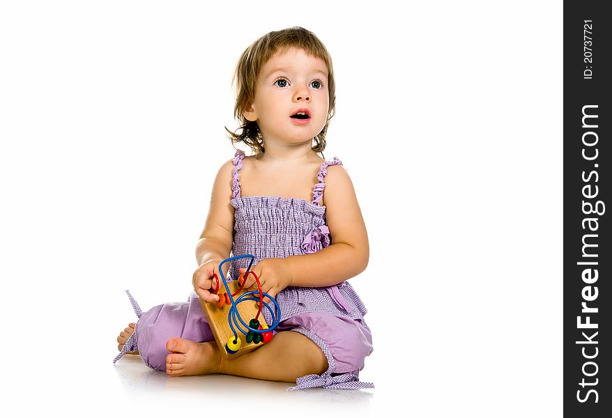 Small baby with developmental toy on a white background